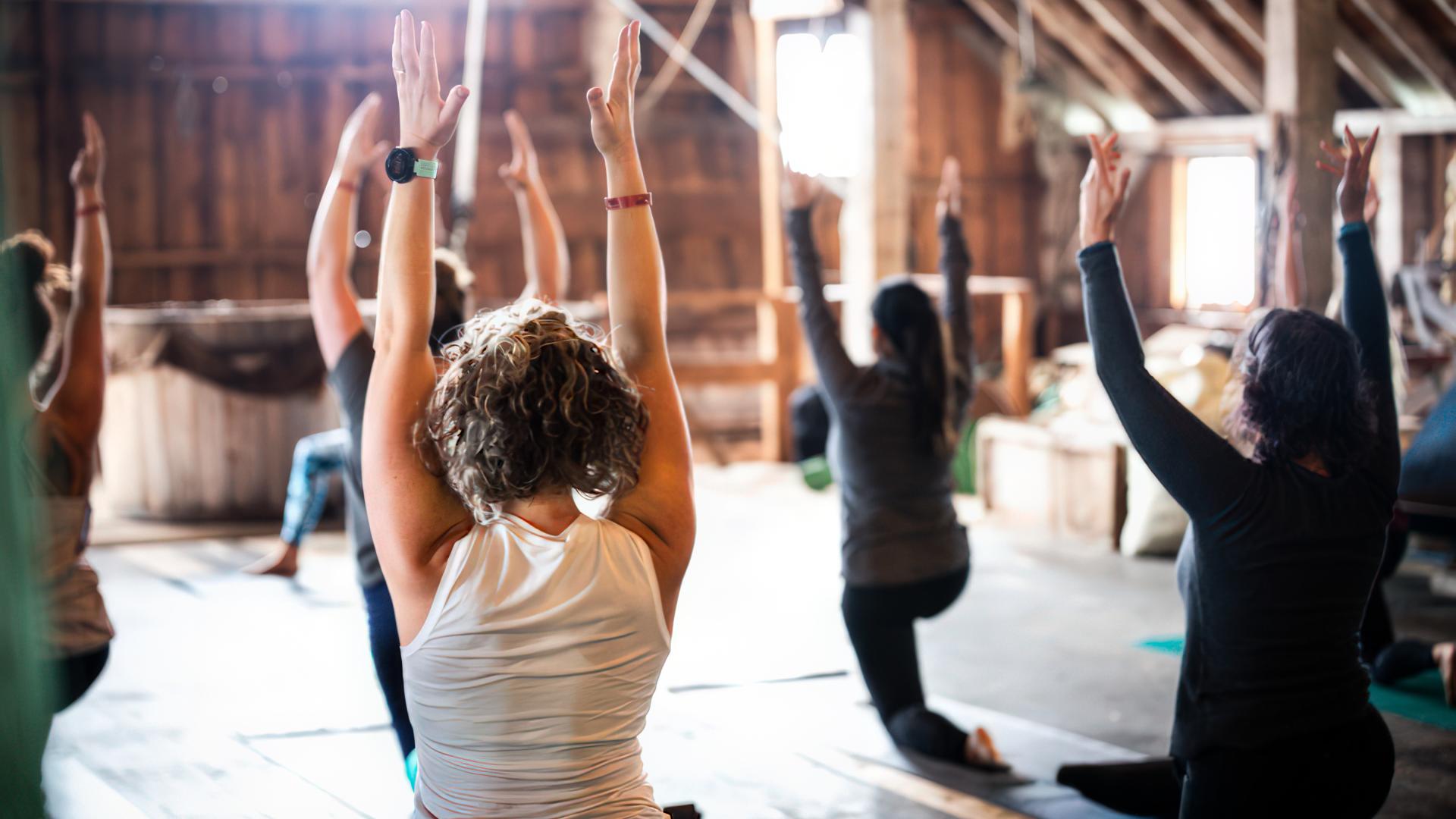People doing yoga in a wooden space