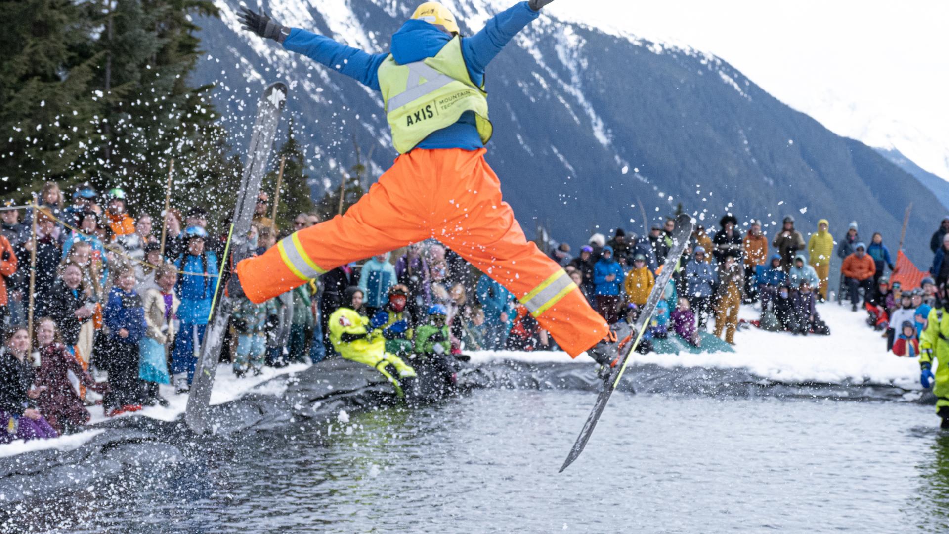 Skier doing a jump over a pool of water at Shames Mountain