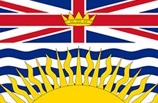 British Columbia flag. There is a sun at the bottom half over some wavy blue lines. There is a Union Jack with a crown in the middle on the upper half of the flag.